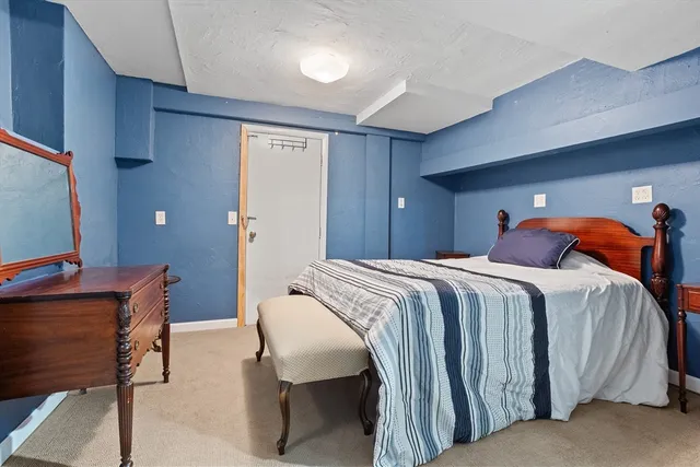 a bedroom with a bed and lamp