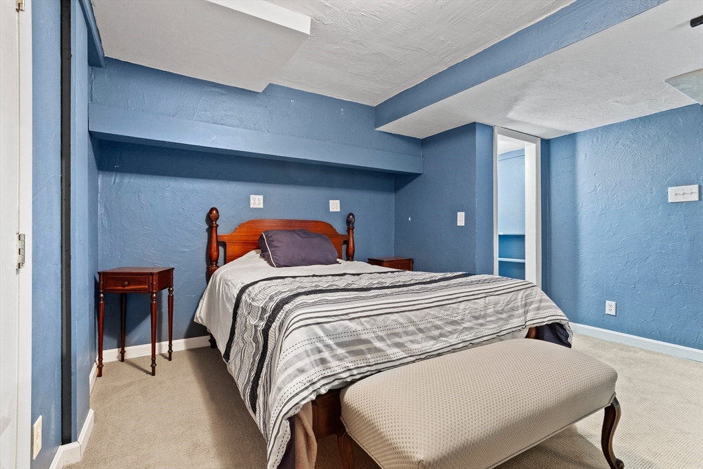 16 Middlesex Street, Unit 4 Chelmsford, MA 01863 - Photo 21 of 25 a bedroom with a bed and lamp