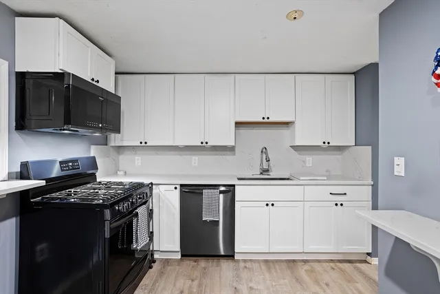 a kitchen with granite countertop a sink and a stove top oven