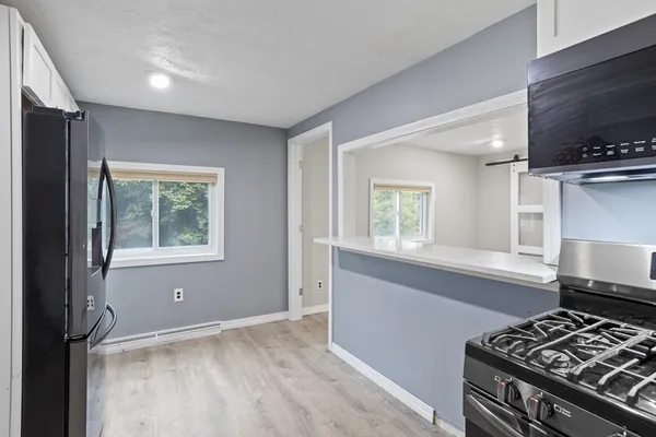 a kitchen with a stove and a window