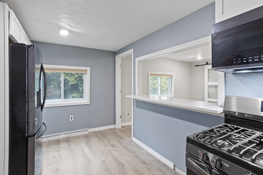 16 Middlesex Street, Unit 4 Chelmsford, MA 01863 - Photo 9 of 25 a kitchen with a stove and a window