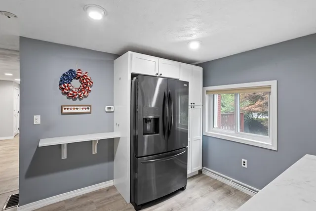 a kitchen with stainless steel appliances a refrigerator and a window
