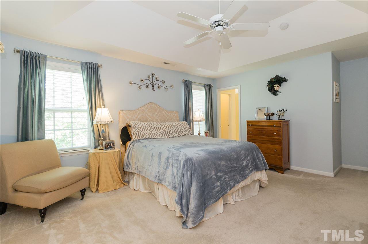 4809 Hodfield Court Raleigh, NC 27604 - Photo 14 of 22 a bedroom with a bed couch and window