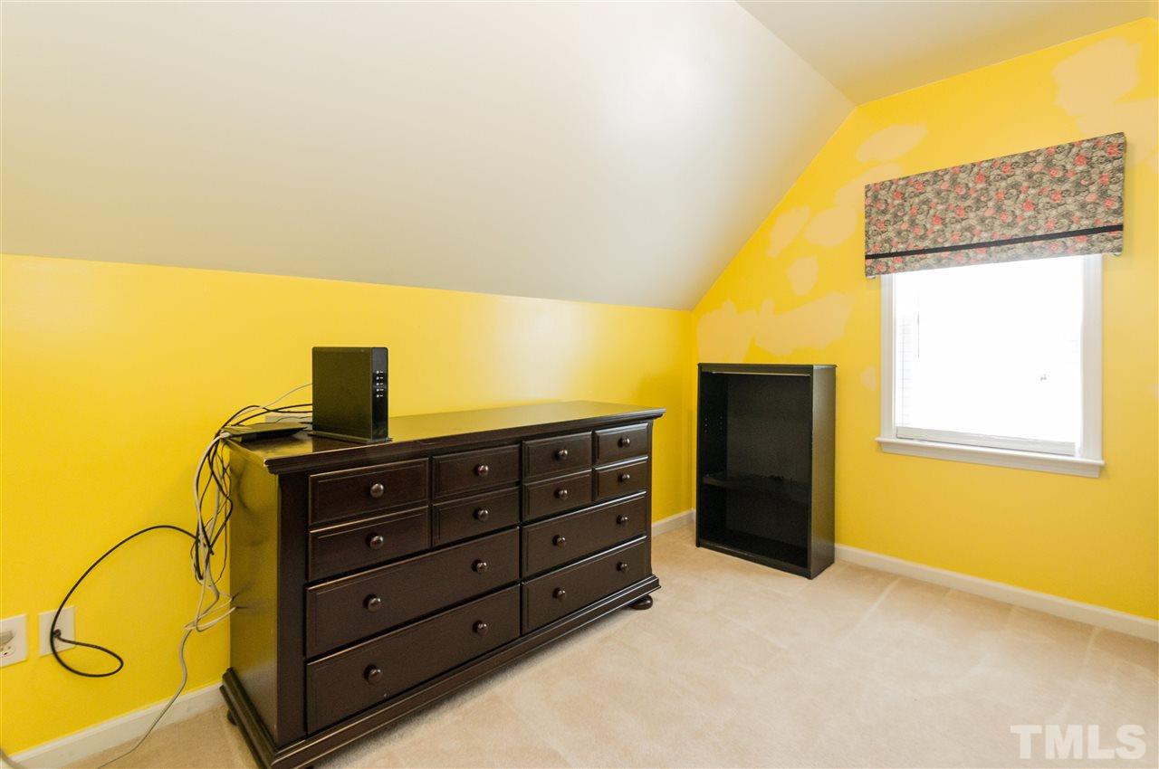 4809 Hodfield Court Raleigh, NC 27604 - Photo 20 of 22 a bedroom with a bed and cabinets