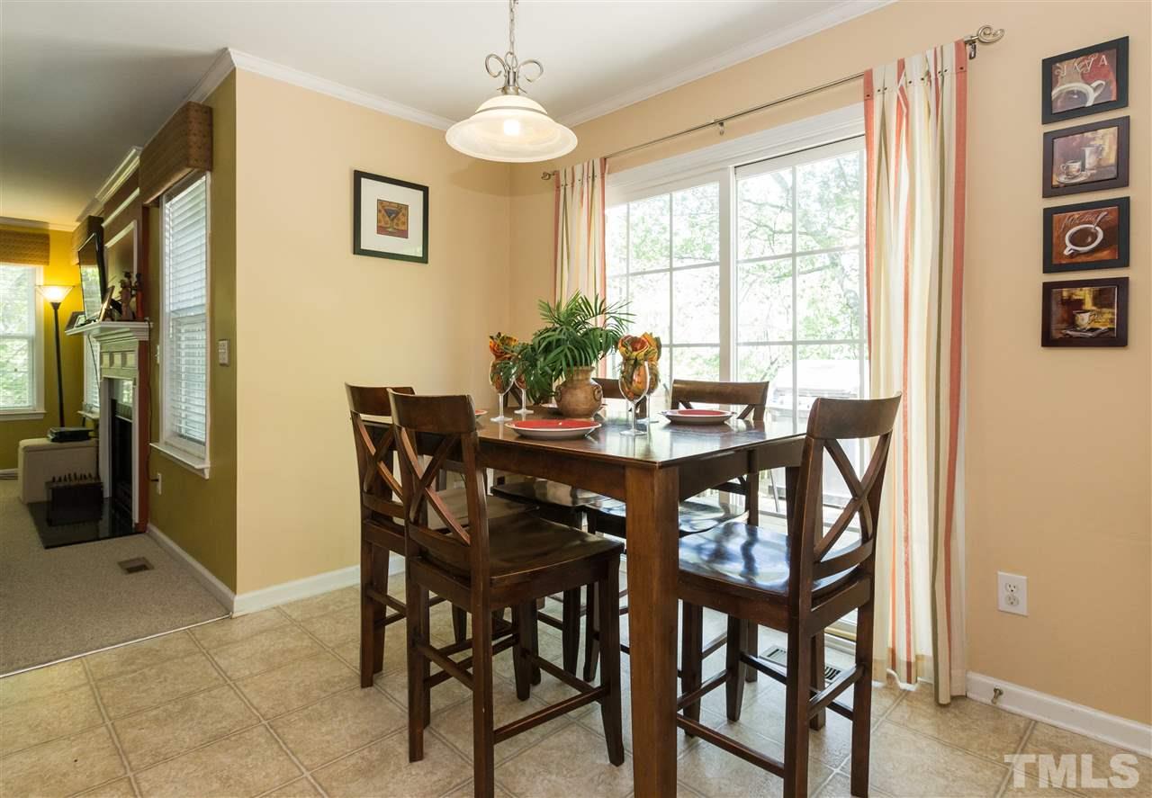 4809 Hodfield Court Raleigh, NC 27604 - Photo 9 of 22 a view of a dining room with furniture and a chandelier