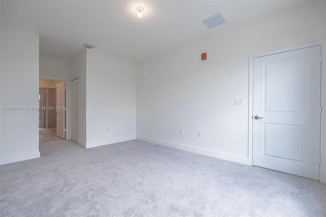 a spacious bathroom with a shower sink and mirror