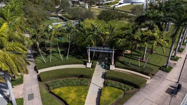 a front view of a house with a yard and lake view
