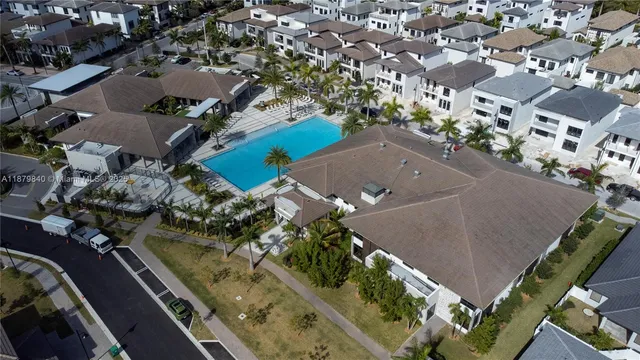 an aerial view of multiple houses with yard