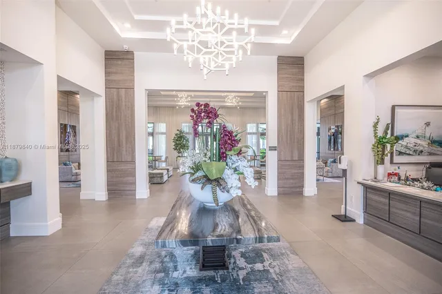 a living room with patio furniture and a potted plant