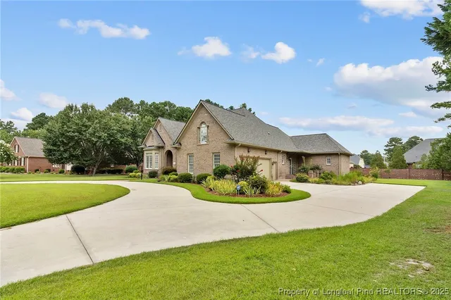 a front view of a house with a garden and yard