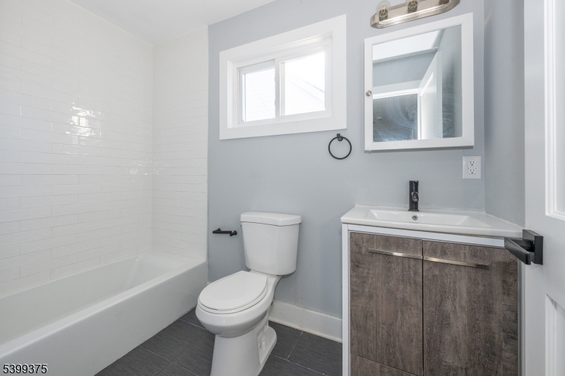17 Peachtree Road, Unit 2 Maplewood, NJ 07040 - Photo 13 of 14 a bathroom with a sink a toilet and shower