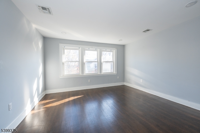 17 Peachtree Road, Unit 2 Maplewood, NJ 07040 - Photo 4 of 14 an empty room with wooden floor and windows