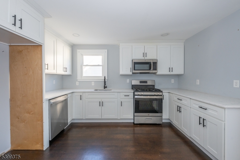 17 Peachtree Road, Unit 2 Maplewood, NJ 07040 - Photo 6 of 14 a kitchen with granite countertop white cabinets and stainless steel appliances