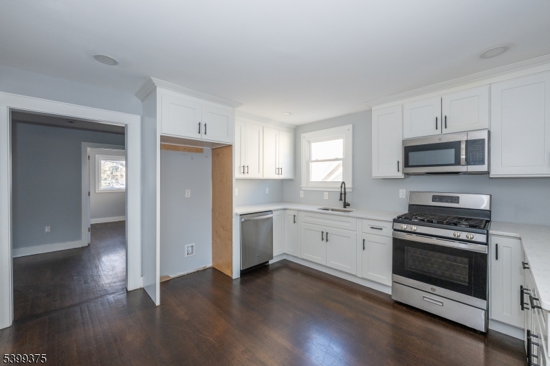 17 Peachtree Road, Unit 2 Maplewood, NJ 07040 - Photo 7 of 14 a kitchen with granite countertop a stove a sink and a refrigerator