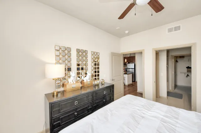 a bedroom with a large bed and a window