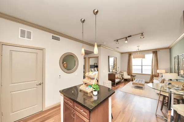 a kitchen with granite countertop a refrigerator and a sink