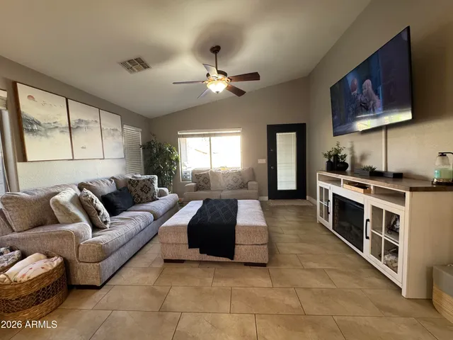 a living room with furniture fireplace and a flat screen tv