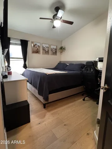 a bedroom with a bed and a large mirror