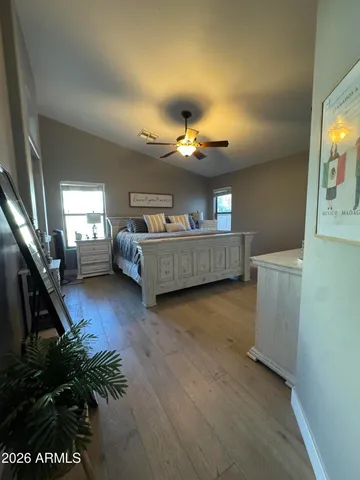 a bedroom with a bed and a chandelier