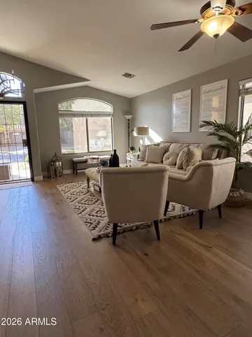 a living room with furniture window and wooden floor