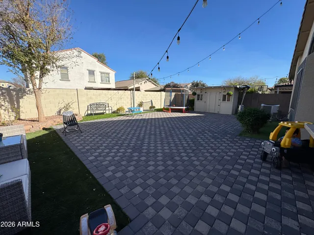 a view of a house with backyard and sitting area