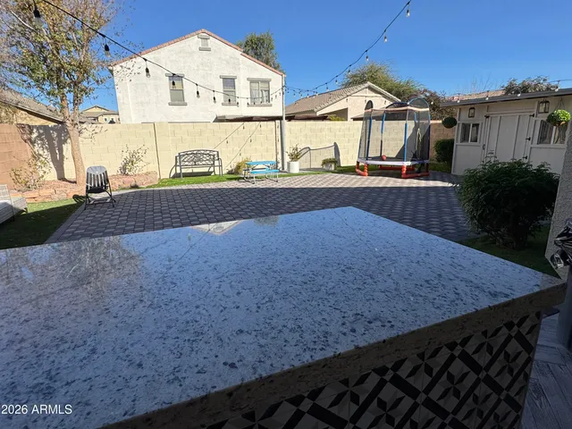 a view of a patio with a table and chairs