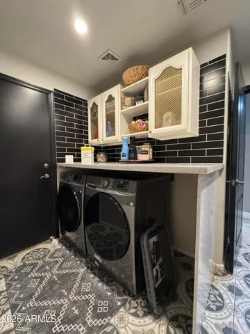 a kitchen with stainless steel appliances granite countertop a stove top oven a sink a counter top space and cabinets