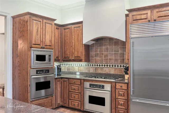 a kitchen with granite countertop a stove and a microwave