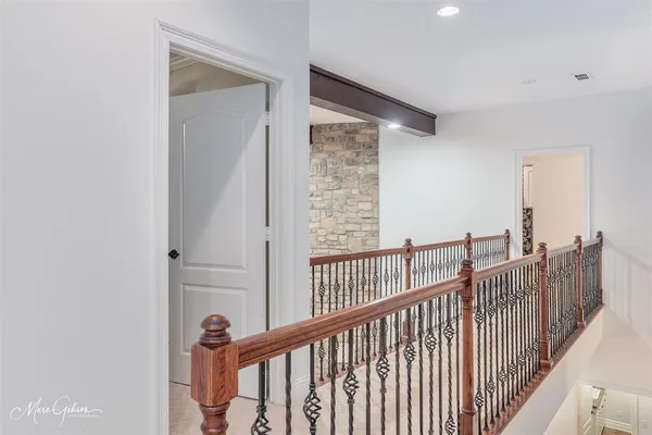 a view of staircase with railing and white walls