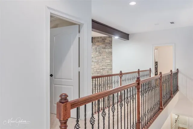 a view of staircase with railing and white walls