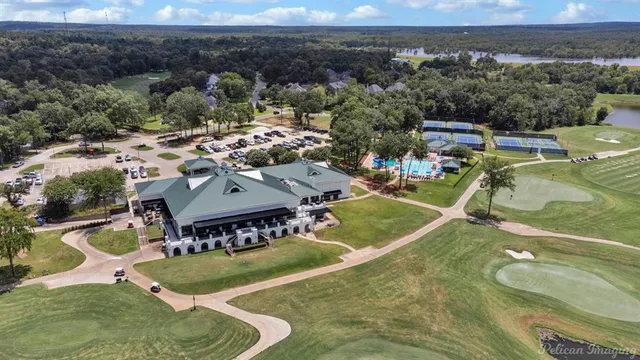 an aerial view of a house with a garden and lake view