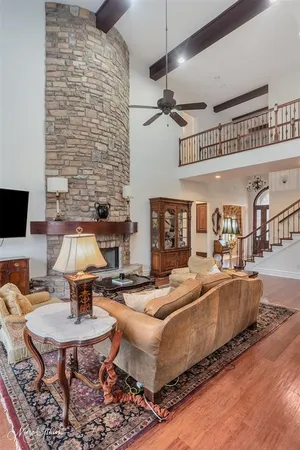 a living room with fireplace furniture and a rug