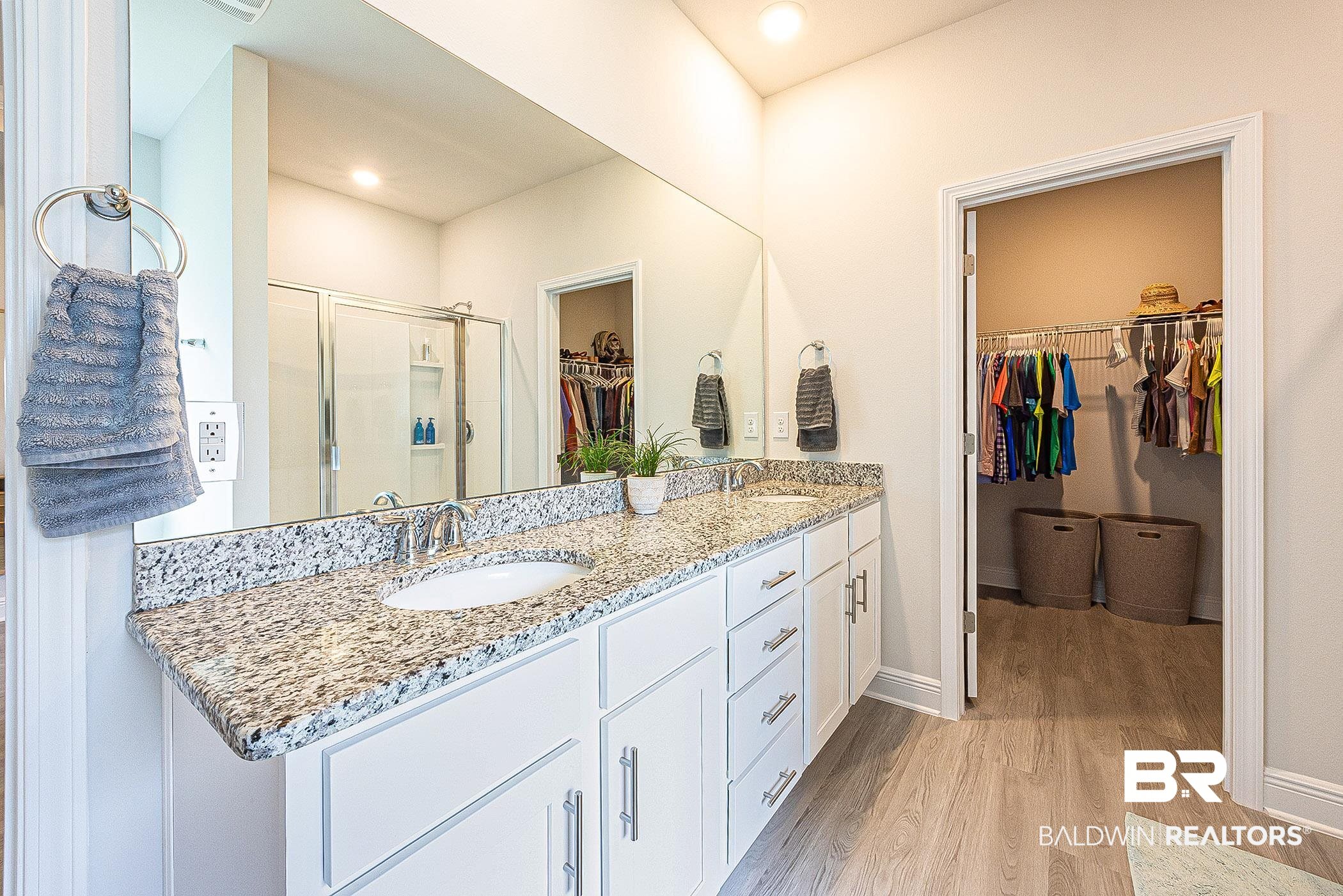 11044 Native Dancer Way Daphne, AL 36526 - Photo 20 of 67 Bathroom featuring a shower with shower door, wood-type flooring, and dual bowl vanity