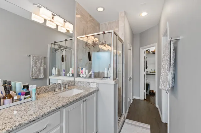 a bathroom with a granite countertop sink mirror and vanity