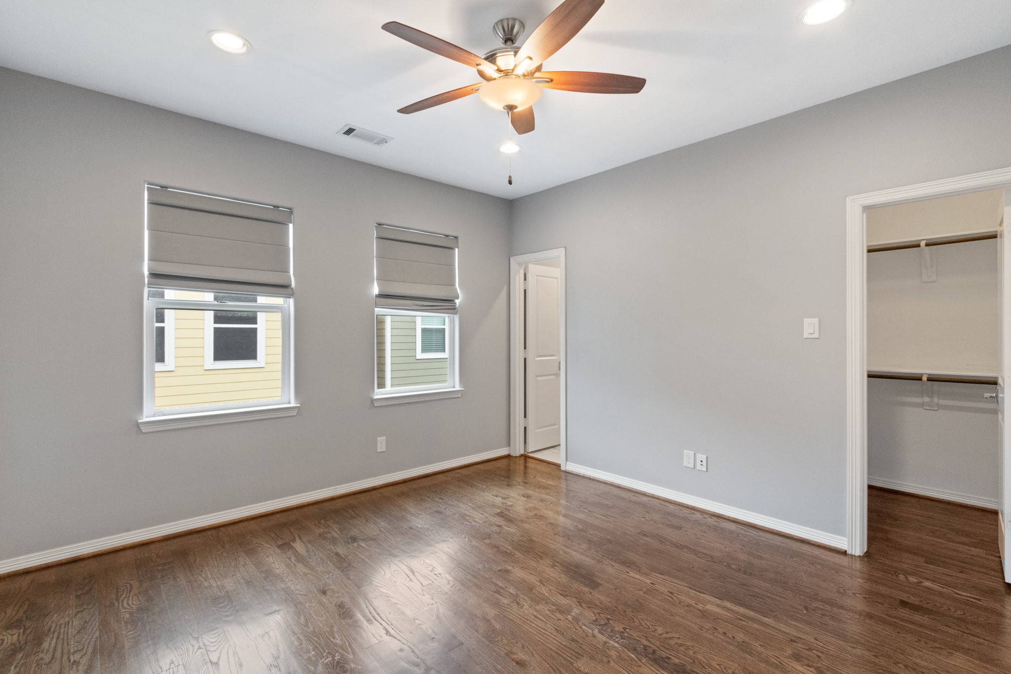 2409 Lawrence Street Houston, TX 77008 - Photo 18 of 21 an empty room with wooden floor ceiling fan and windows