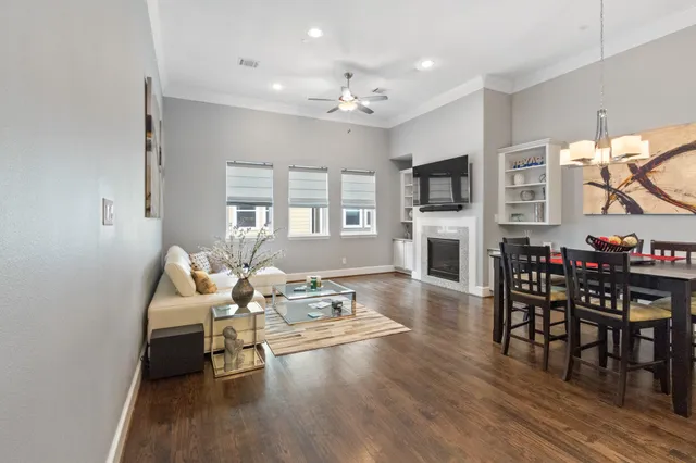 a living room with furniture a fireplace and a flat screen tv