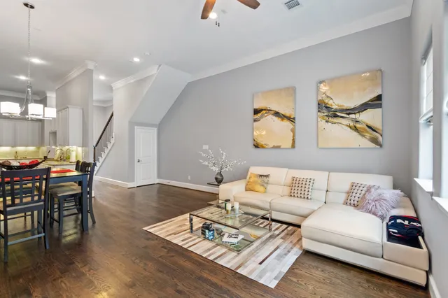 a living room with furniture and wooden floor