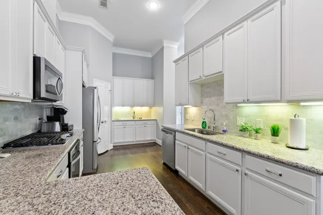 a kitchen with a sink stove and cabinets