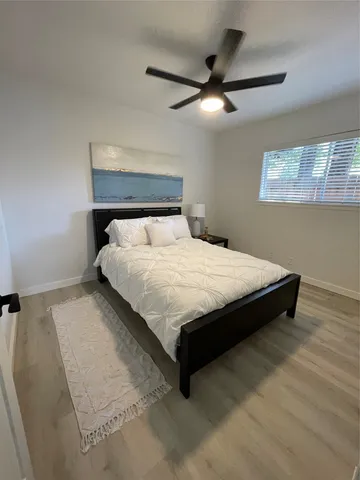 a large bed sitting in a bedroom and chandelier