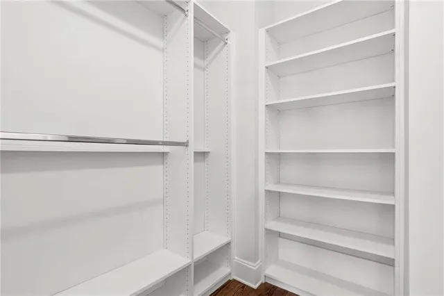 a view of walk in closet with empty racks