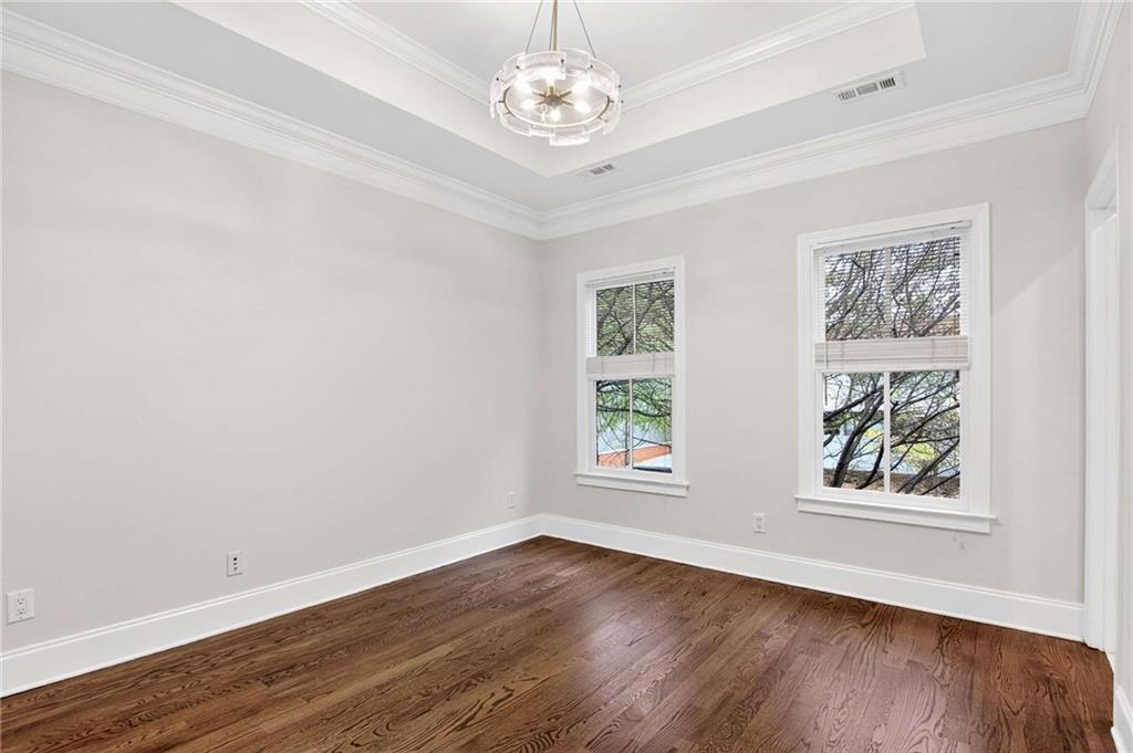 841 Inman Village Parkway Northeast Atlanta, GA 30307 - Photo 19 of 27 a view of an empty room with wooden floor and a window