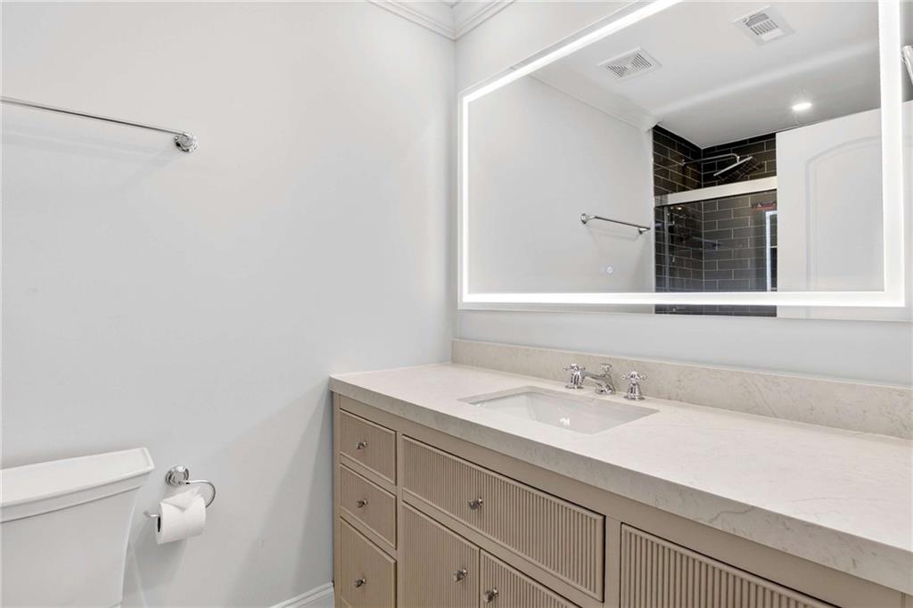 841 Inman Village Parkway Northeast Atlanta, GA 30307 - Photo 24 of 27 a bathroom with a sink a vanity and a toilet