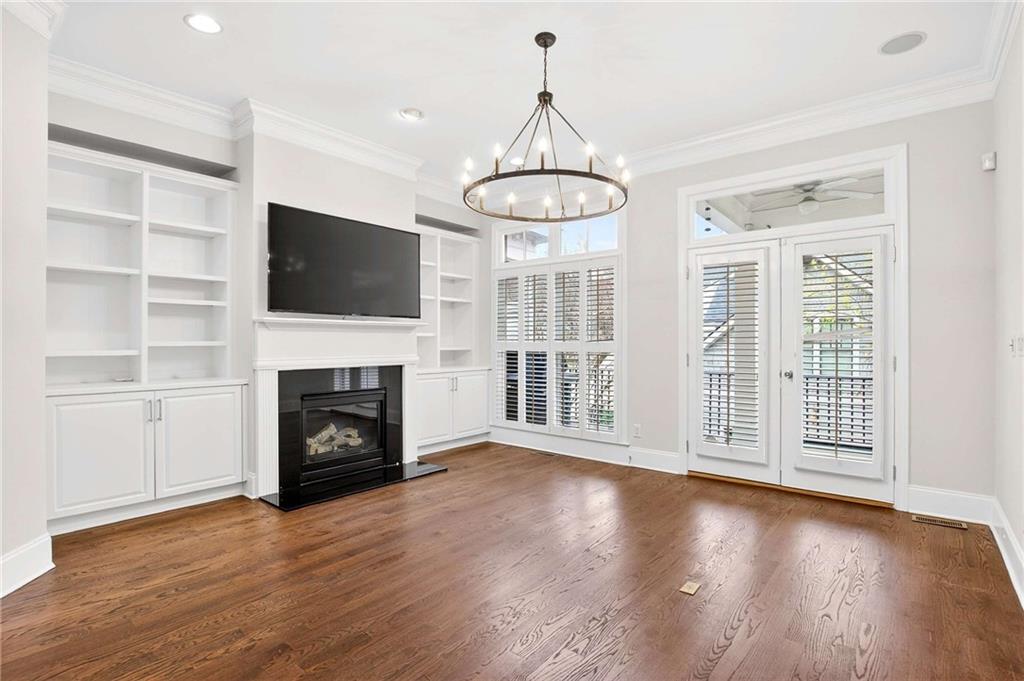 841 Inman Village Parkway Northeast Atlanta, GA 30307 - Photo 6 of 27 a view of a livingroom with a fireplace wooden shelves and windows