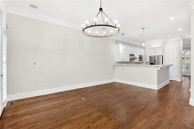 a view of a kitchen with a sink cabinets and wooden floor