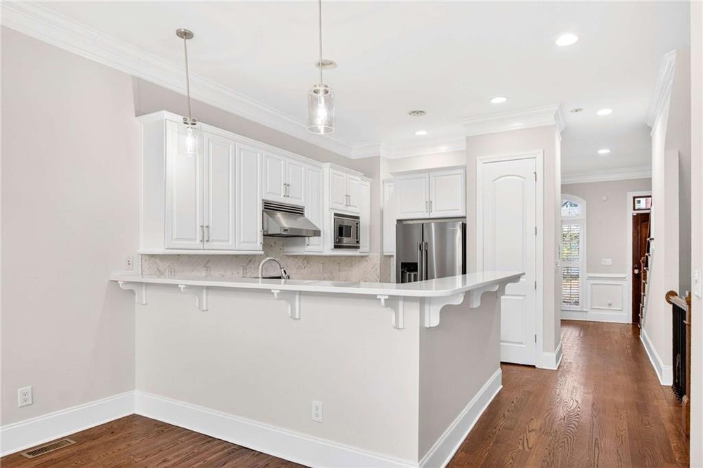 841 Inman Village Parkway Northeast Atlanta, GA 30307 - Photo 8 of 27 a kitchen with stainless steel appliances a refrigerator and a stove top oven