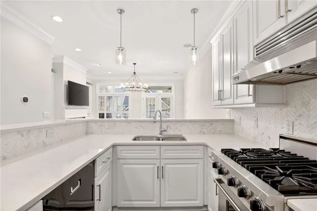 a kitchen with stainless steel appliances a sink stove and cabinets