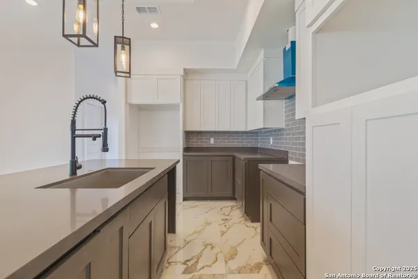 a kitchen with a sink stove and cabinets