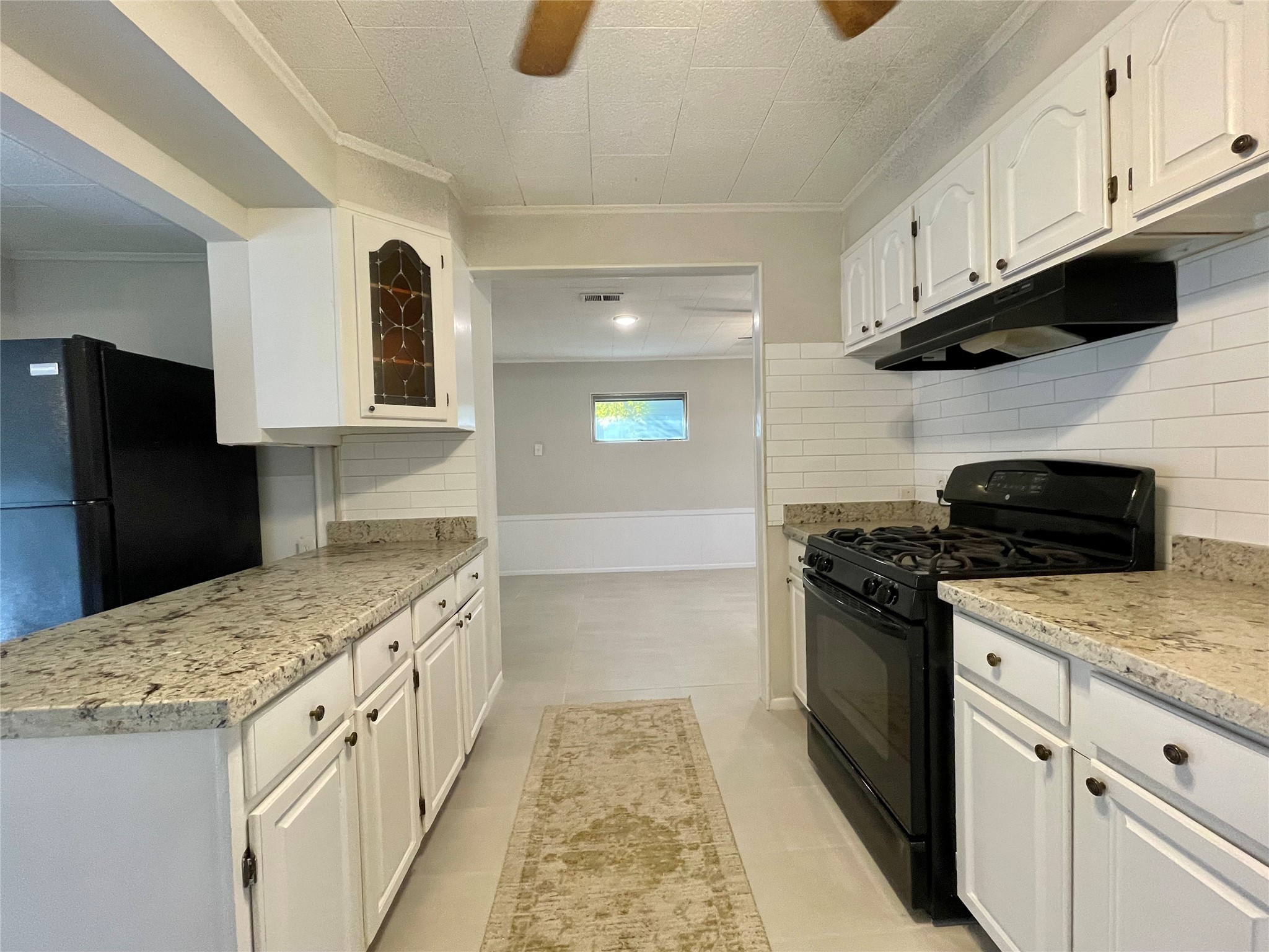 1112 Southampton Drive Angleton, TX 77515 - Photo 12 of 36 a kitchen with stainless steel appliances granite countertop a stove and a refrigerator