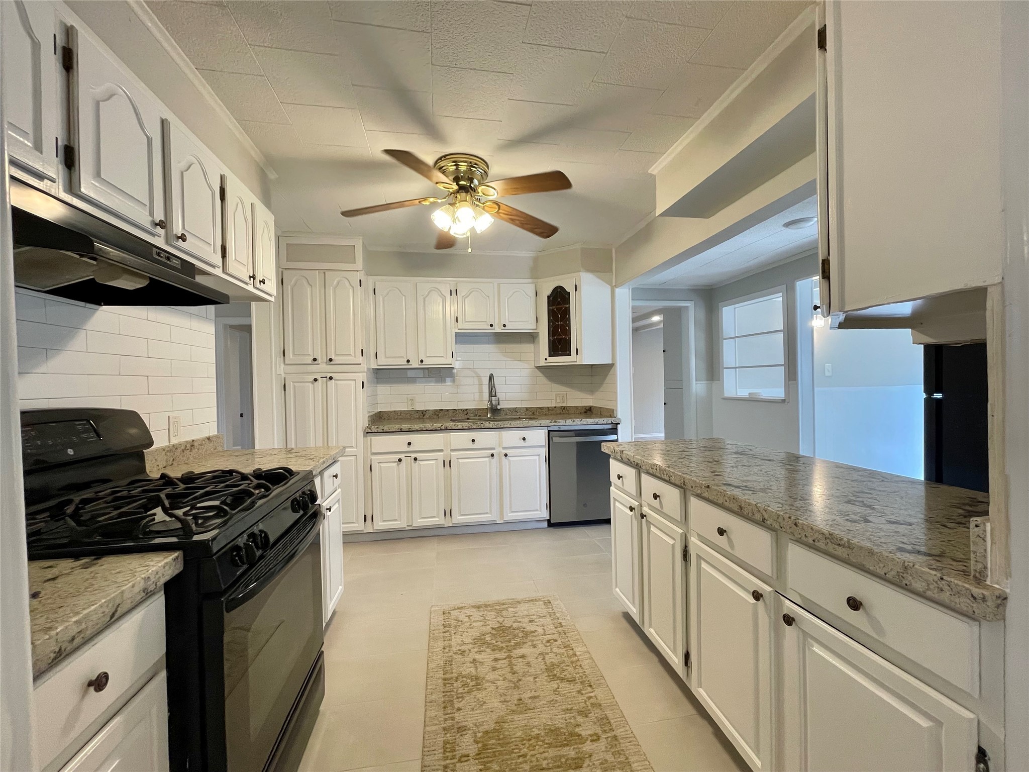 1112 Southampton Drive Angleton, TX 77515 - Photo 13 of 36 a kitchen with stainless steel appliances granite countertop a stove a sink and a refrigerator
