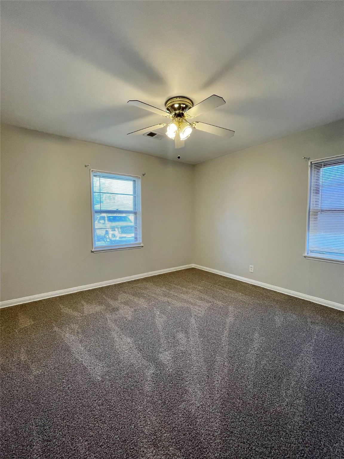 1112 Southampton Drive Angleton, TX 77515 - Photo 27 of 36 an empty room with a ceiling fan and window